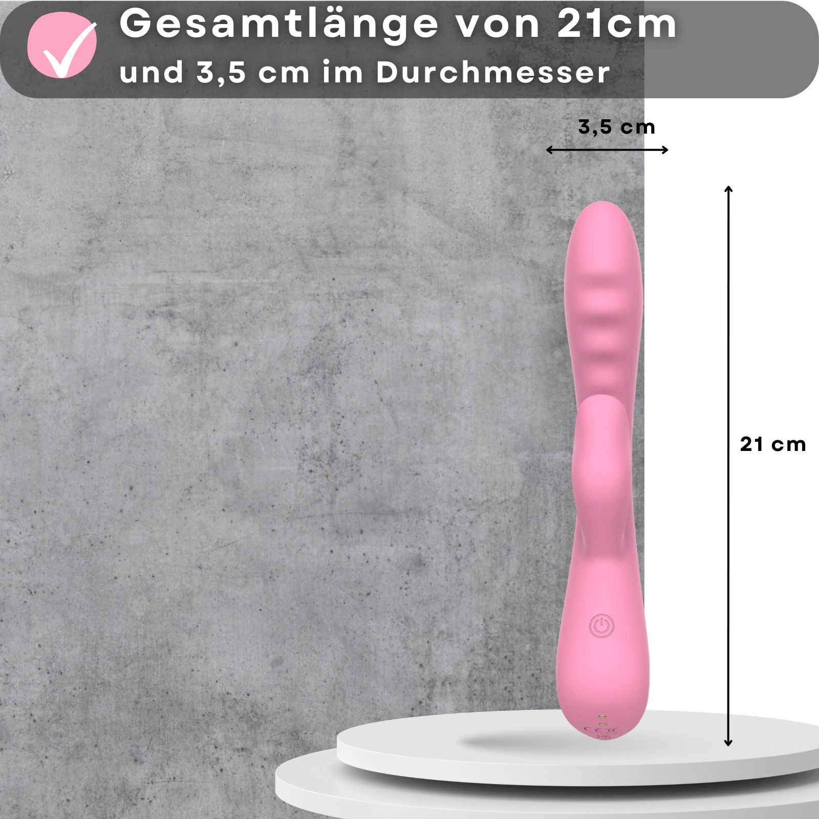 Rosa Vibrator. Länge 21cm, Durchmesser 3,5cm. Auf weißer Oberfläche. Grauer Hintergrund. Maße angegeben.