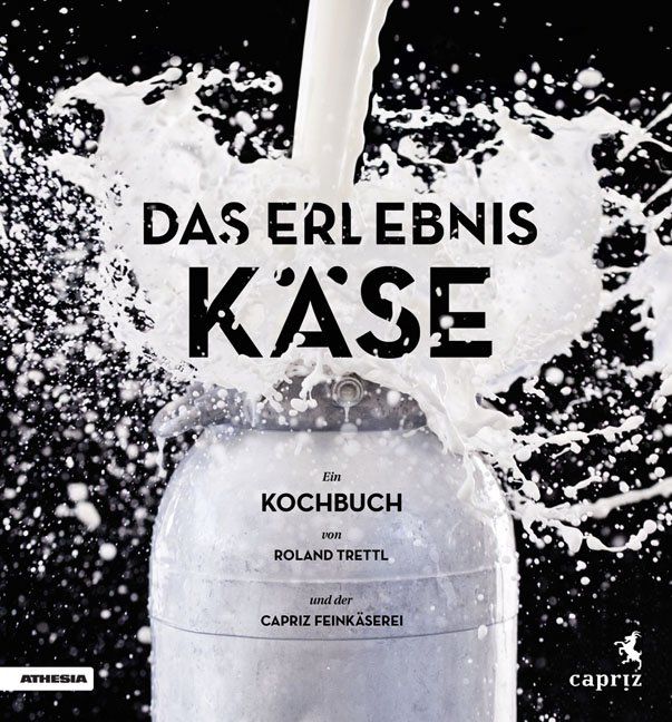 Kochbuch "Das Erlebnis Käse". Milch spritzt auf eine Metallflasche. Titel, Autor und Verlag sind sichtbar.