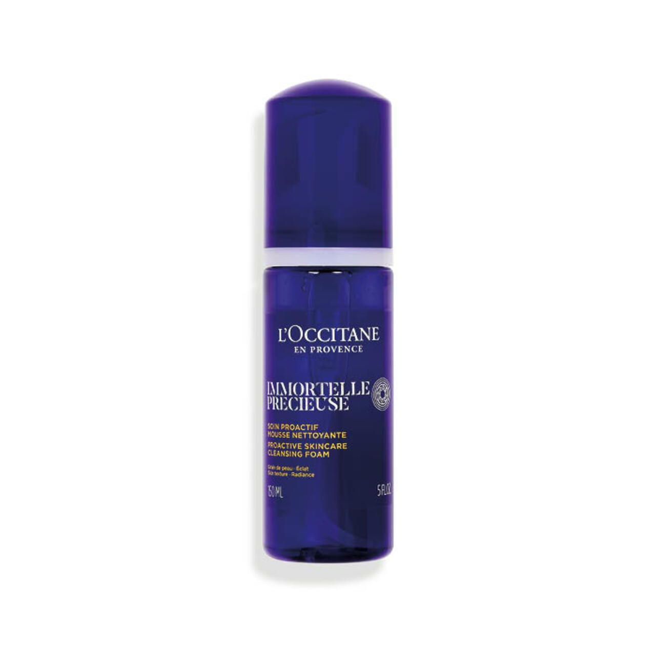 Blauwe Flasche mit L'Occitane Immortelle Reinigungsschaum. Aufschrift: Immortelle Précieuse, 5 fl oz.
