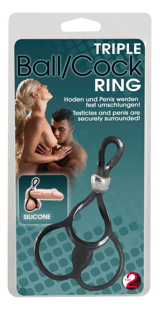 Verpackung mit Produktabbildung. Schwarzer Ring mit silberfarbenem Verbindungsstück. Text: Triple Ball/Cock Ring.