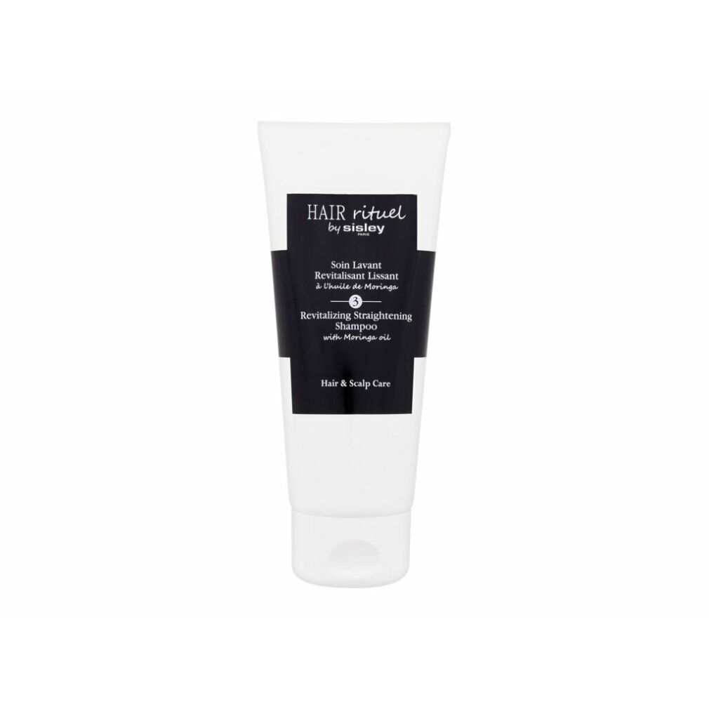 Weißer Tube mit schwarzem Etikett. Aufschrift: Hair Rituel by Sisley, Revitalizing Straightening Shampoo. Produkt für Haar und Kopfhaut.