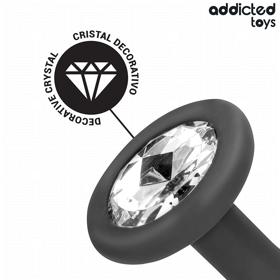 Nahaufnahme eines grauen Analplugs mit Kristall. Ovale Basis mit Kristall. Text: Cristal Decorativo, Addicted Toys.