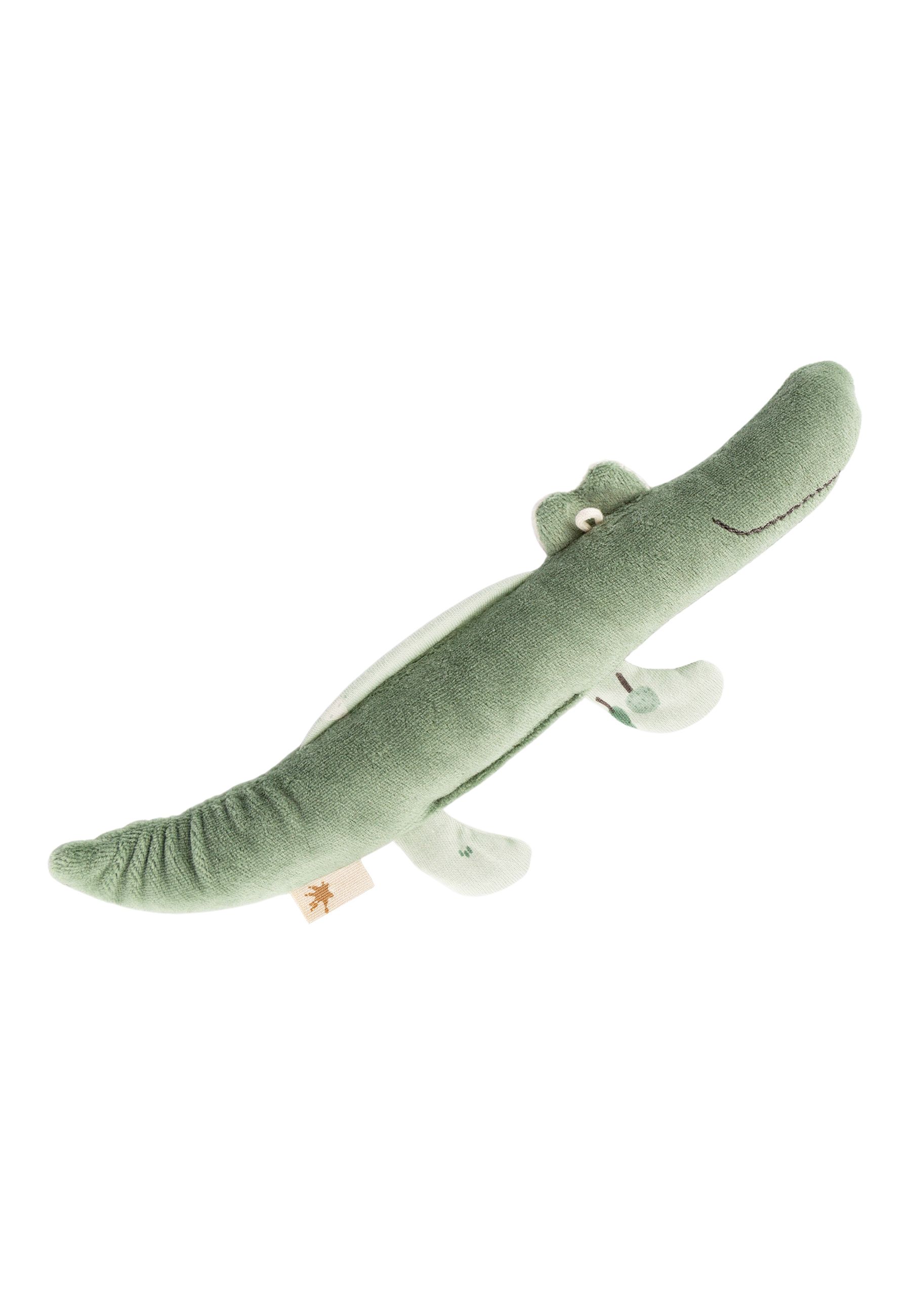 Grünes Krokodil-Greifspielzeug. Weiches Material, helle Bauchpartie, kleine Füße. Label mit Logo. Seitliche Ansicht.