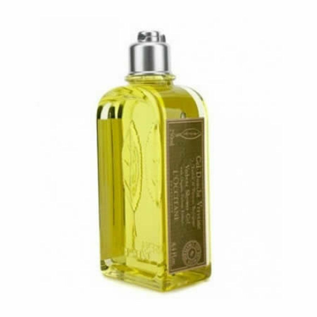 Gelbe Flüssigkeit in einer rechteckigen Flasche mit silbernem Deckel. Aufschrift: Verbene, Gel Douche, L'Occitane. Blattrelief.