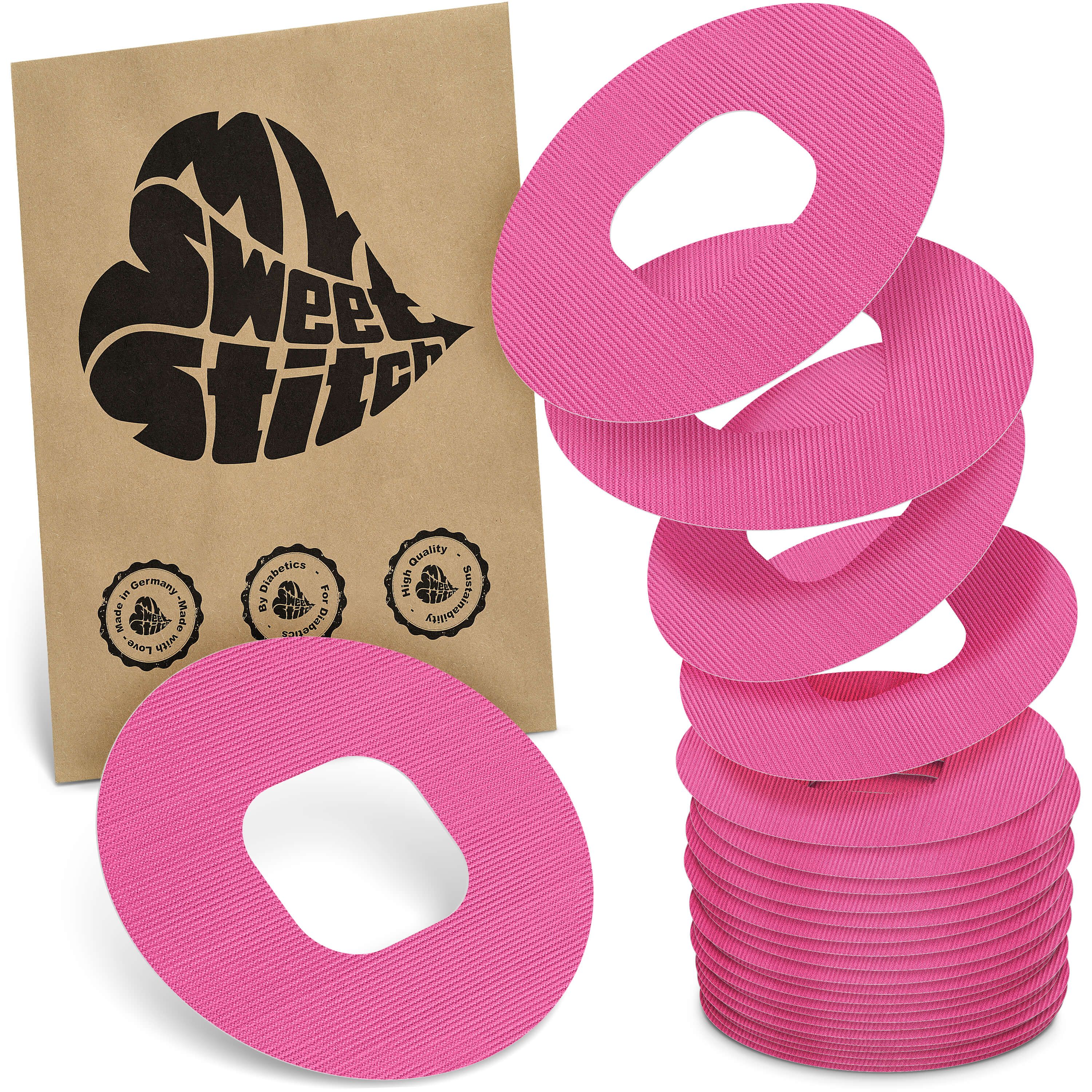 Rosa Ringpflaster mit ovaler Öffnung. Auf brauner Verpackung steht "My Sweet Stitch". Mehrere Pflaster gestapelt und einzeln.