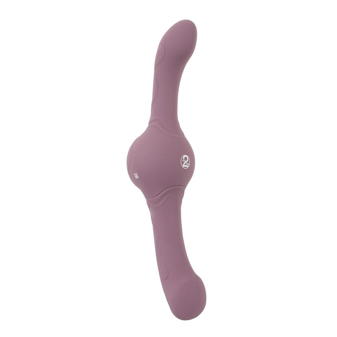 Lila Vibrator mit zwei gebogenen Enden und einem runden Mittelteil. Logo auf dem Mittelteil.