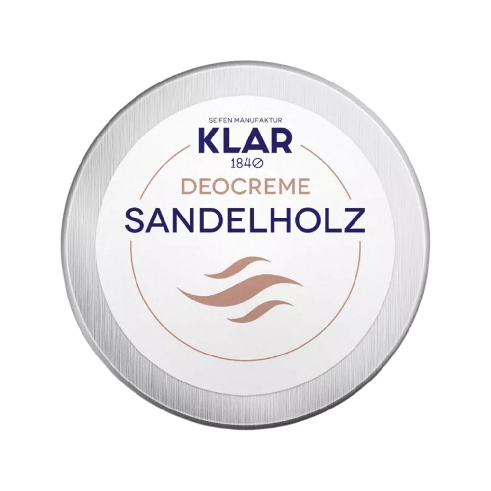 Runder Behälter mit Deckel. Aufschrift: KLAR Deocreme Sandelholz. Braune Wellen-Grafik.