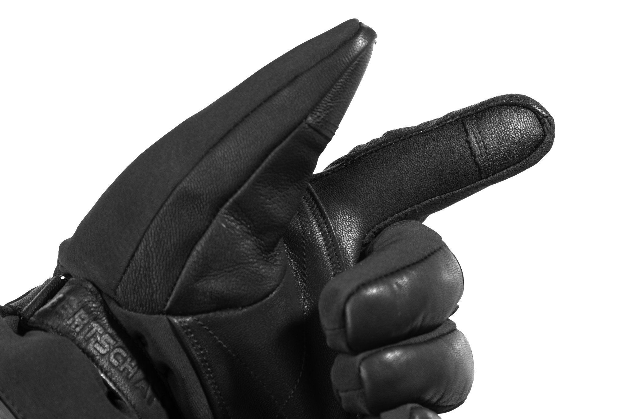 Nahaufnahme eines schwarzen Handschuhs. Leder an der Handfläche und am Daumen. Schwarzes Textilmaterial.
