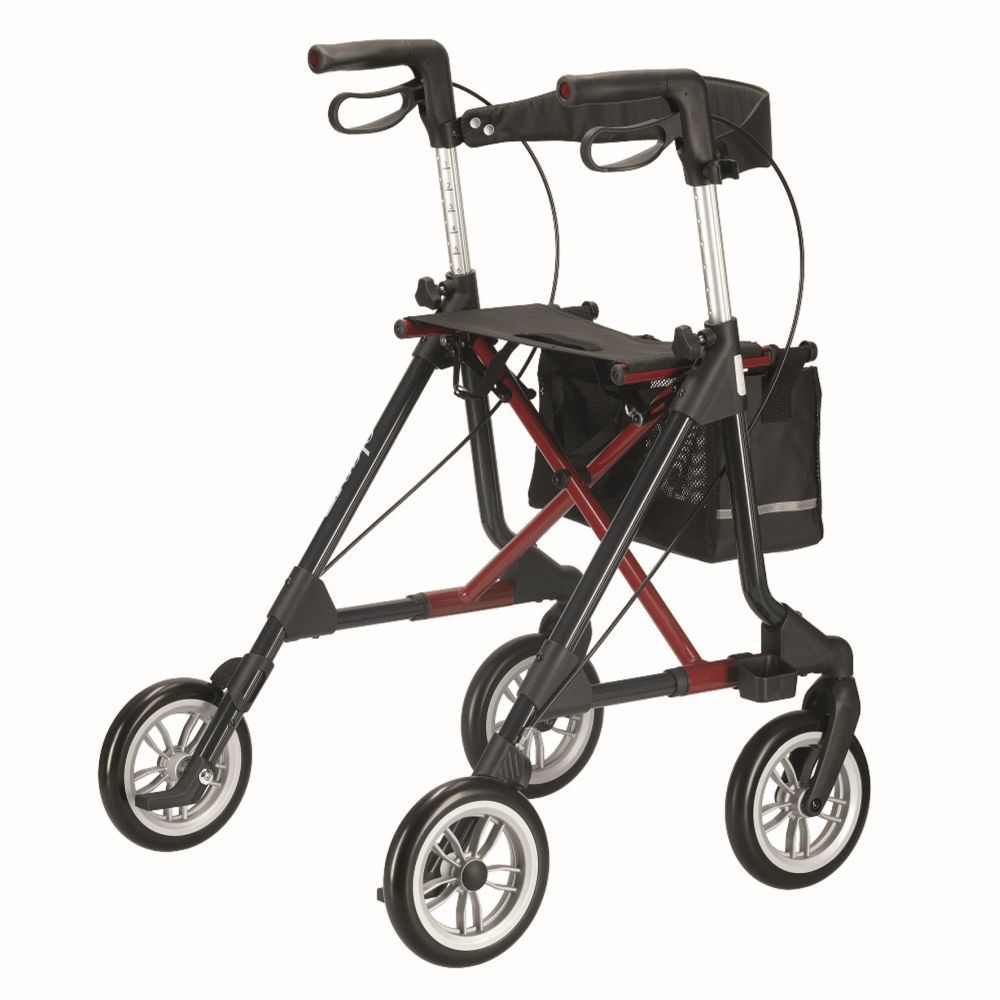 Rollator mit schwarzem Sitz, Korb und weichen Rädern. Schwarzer Rahmen mit roten Akzenten. Vier Räder.