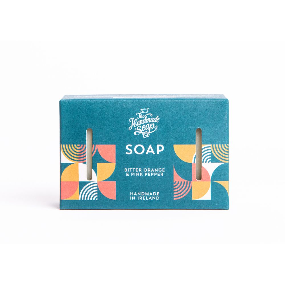 Türkisgrüne Seifenverpackung mit dem Logo von The Handmade Soap Co. und der Aufschrift "SOAP". Text: Bitter Orange & Pink Pepper.