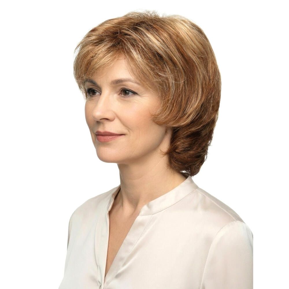 Frau mit Perücke, blond-braune Haare, Seitenansicht. Hellbraune Strähnen, schulterlange Frisur. Trägt eine helle Bluse.