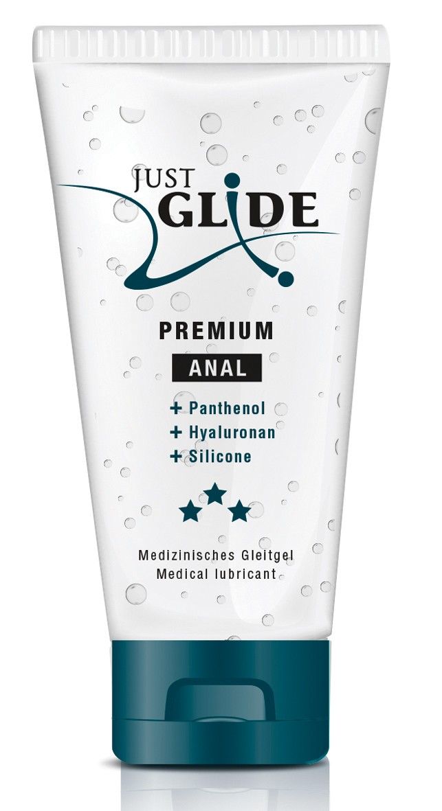 Transparent Tube mit blauem Deckel. Aufschrift: Just Glide Premium Anal. Enthält Panthenol, Hyaluronan, Silikon. Medizinische Gleitgel.