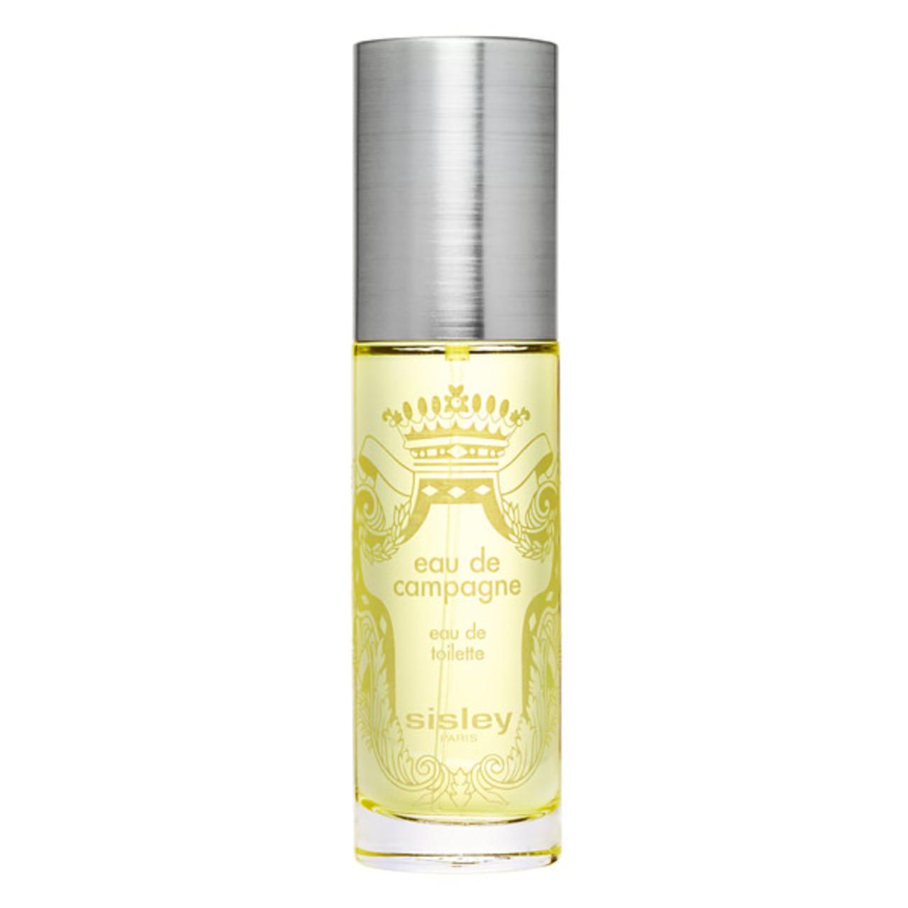 Flakon Eau de Campagne von Sisley. Zylindrische Form, silberner Deckel. Gelbe Flüssigkeit sichtbar. Aufschrift: Eau de Campagne, Eau de Toilette, Sisley.