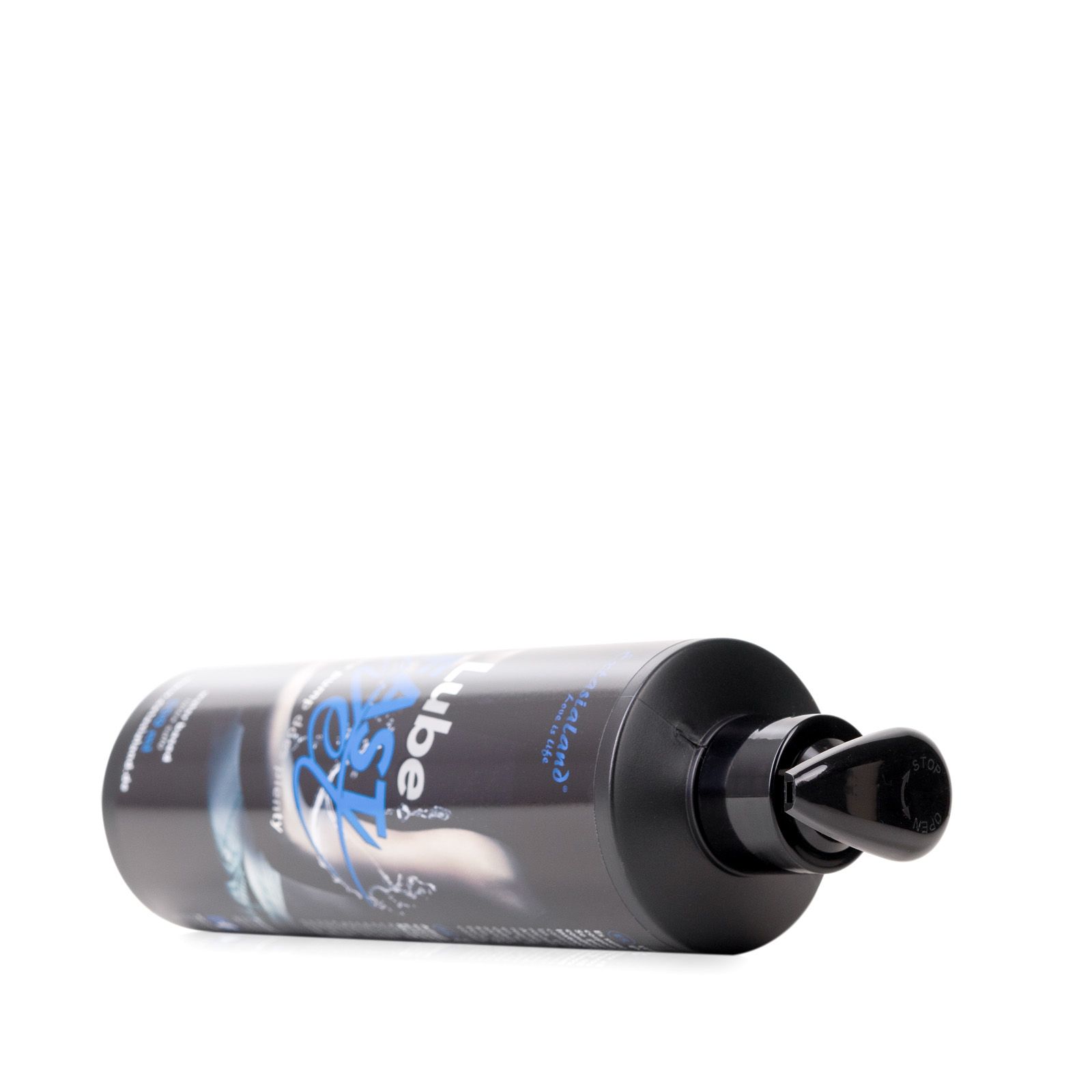 Schwarze Flasche mit Pumpe liegt. "Lube Fast Wet" und Text sichtbar.