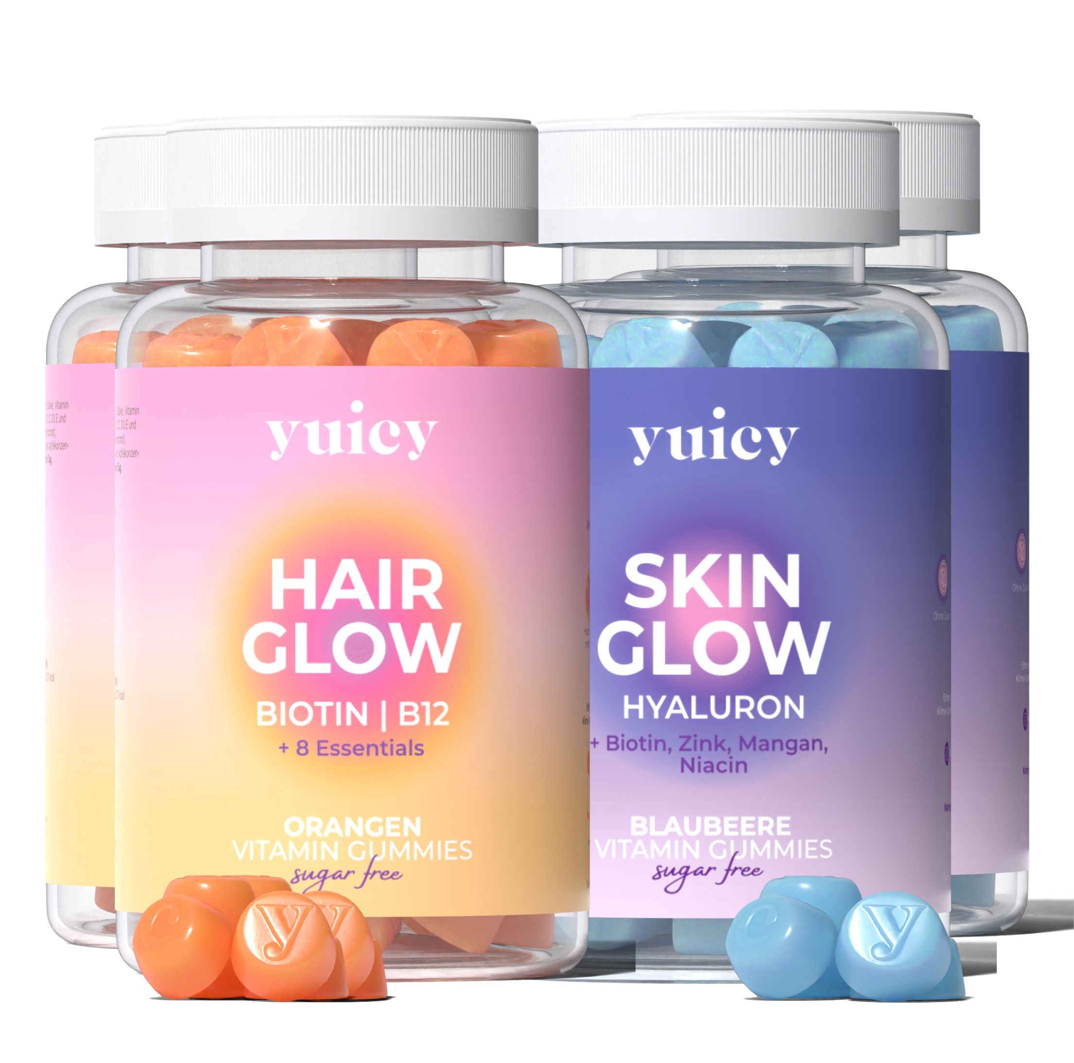 Mehrere Flaschen Vitamin-Gummis. Zwei Sorten: Hair Glow (orange) und Skin Glow (blau). Beide mit yuicy®-Logo.