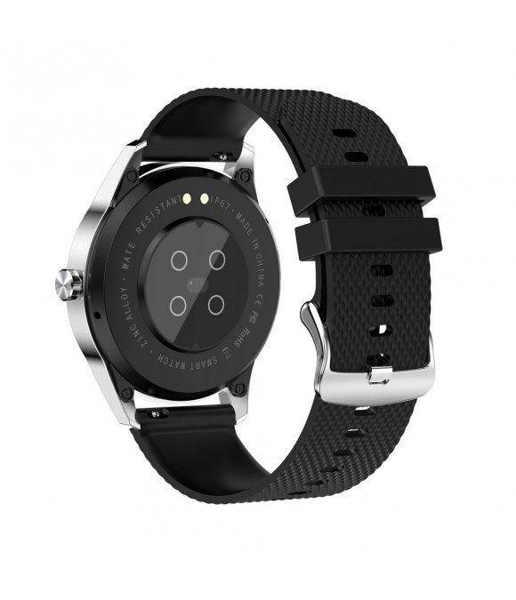 Rückseite einer Smartwatch mit schwarzem Armband. Silbernes Gehäuse. Sensoren und Ladekontakte sichtbar. Schwarzes Armband.