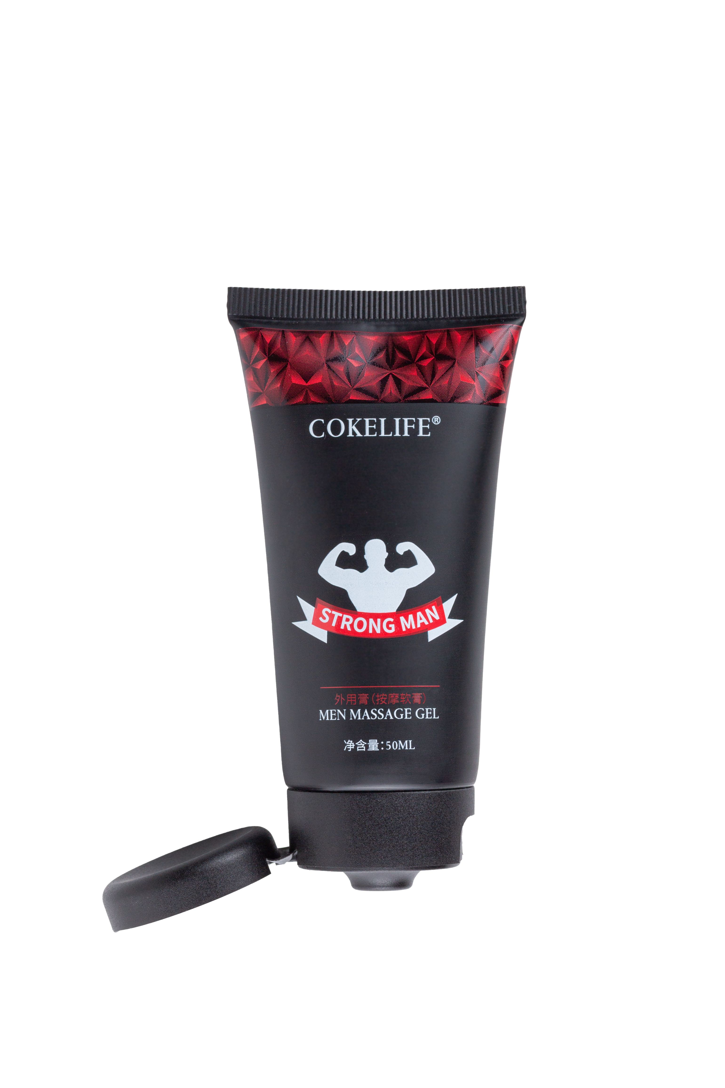 Schwarze Tube mit rotem Muster und Aufschrift. Offener Deckel. Text: COKELIFE, STRONG MAN, MEN MASSAGE GEL.
