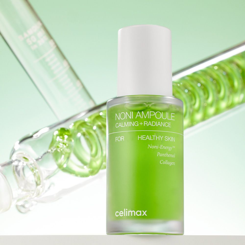 Celimax Noni Energy Ampoule vor einem spiralförmigen grünen Inhalt.