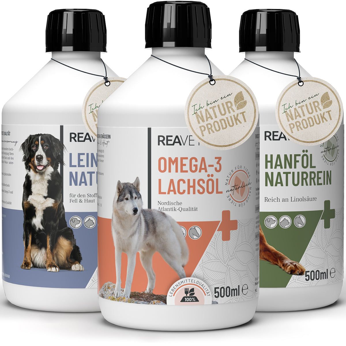 Drei Flaschen mit schwarzen Deckeln. Etiketten mit Hundeabbildungen und Text. Anhänger mit Naturprodukt-Logo.