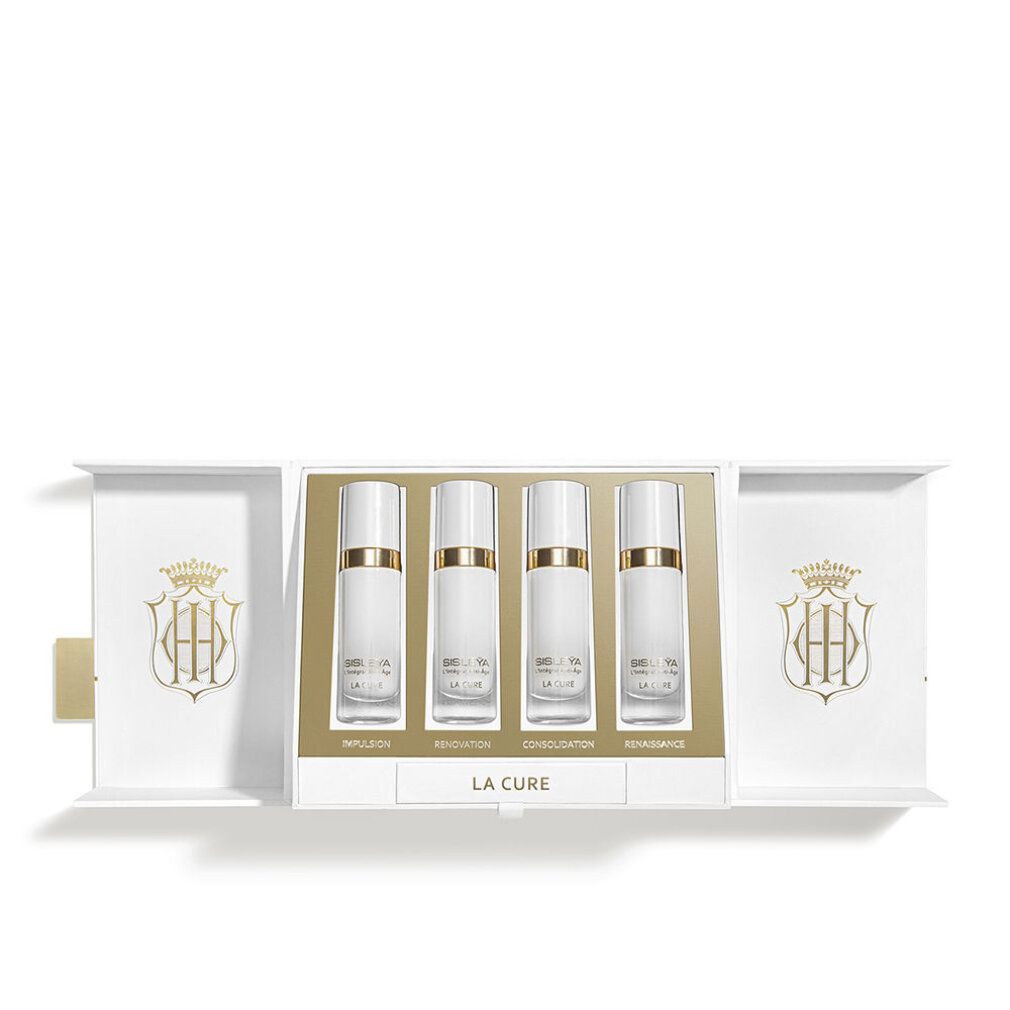 Geöffnete Verpackung mit vier Flakons. Aufschrift: Sisleya L'Intégral Anti-Âge LA CURE. Goldene Akzente.
