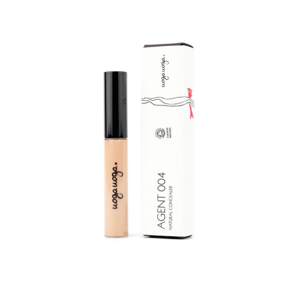 Concealer-Tube und Verpackung. Tube mit schwarzem Deckel, beigefarbener Flüssigkeit. Verpackung mit Text und Logo.