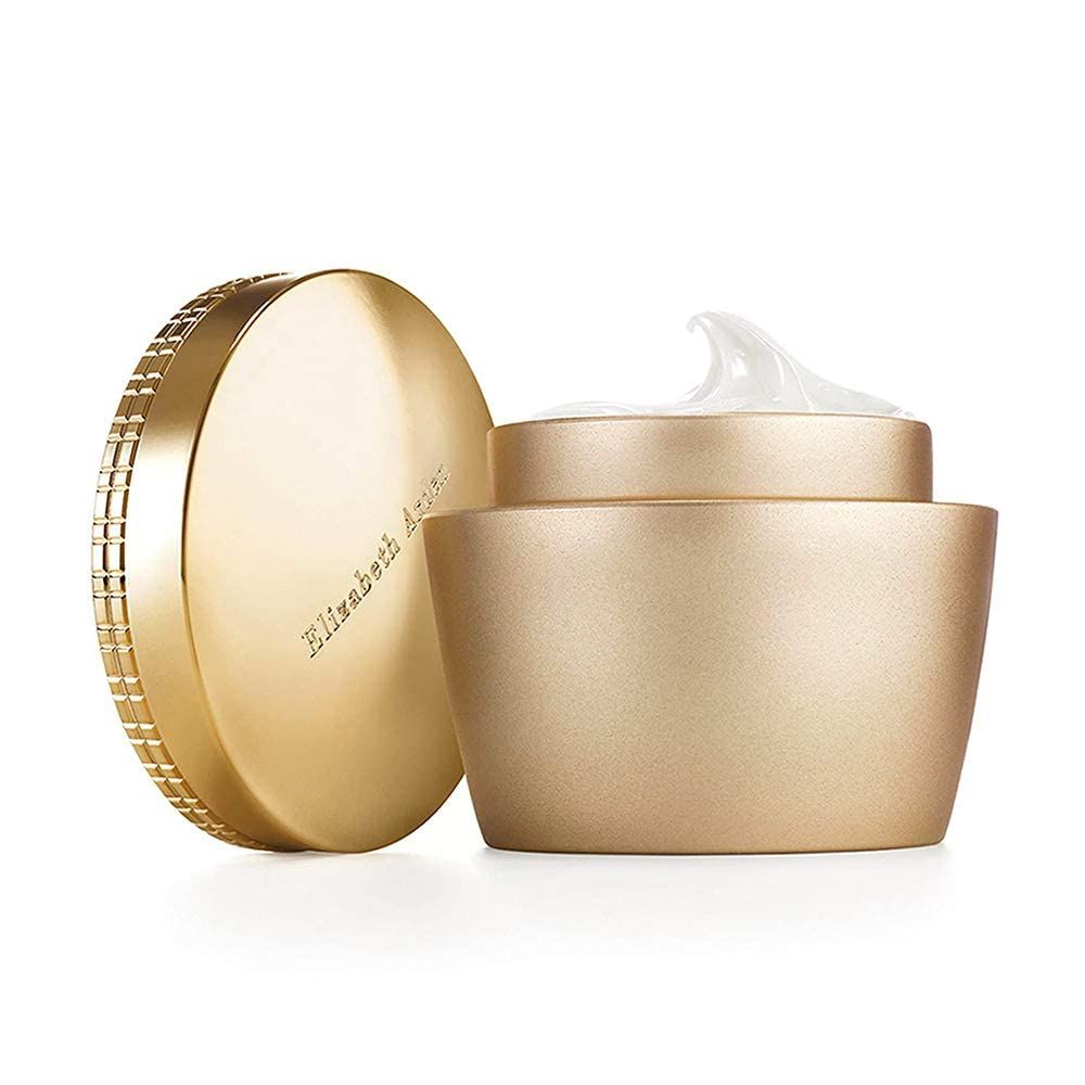 Goldfarbener Tiegel mit geöffnetem Deckel. Der Deckel liegt daneben. Creme ist sichtbar. Auf dem Deckel steht Elizabeth Arden.