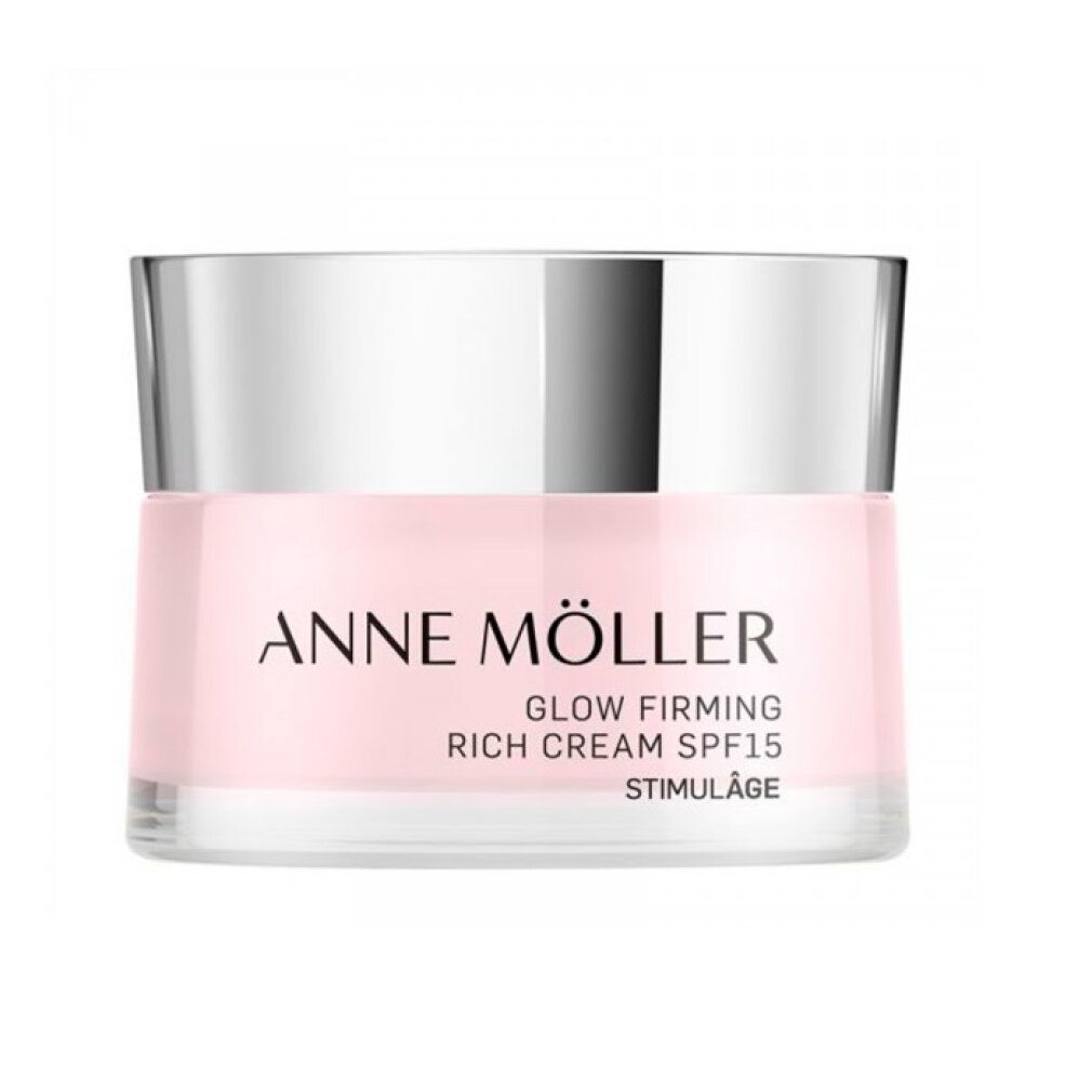 Rosa Creme-Tiegel mit silbernem Deckel. Aufschrift: ANNE MÖLLER, GLOW FIRMING, RICH CREAM SPF15, STIMULÂGE.