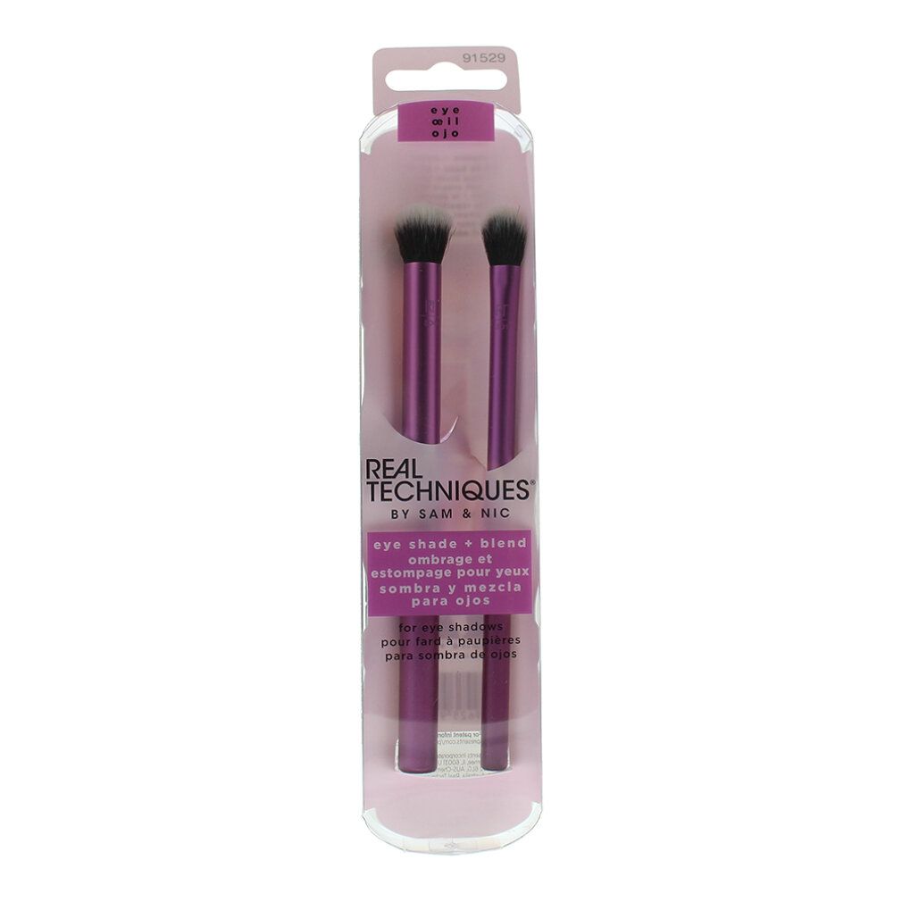 Verpackung mit zwei lila Real Techniques Eye Shade & Blend Pinseln. Text: eye shade + blend.