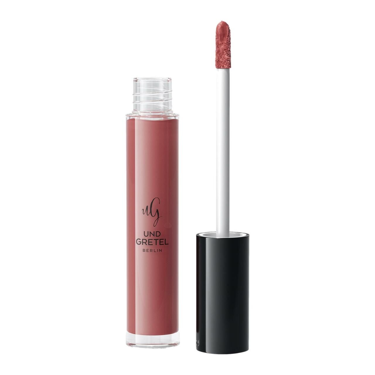 Flüssiger Lippenstift in einer transparenten Flasche mit schwarzem Deckel. Der Applikator ist sichtbar. Aufschrift: UND GRETEL BERLIN.