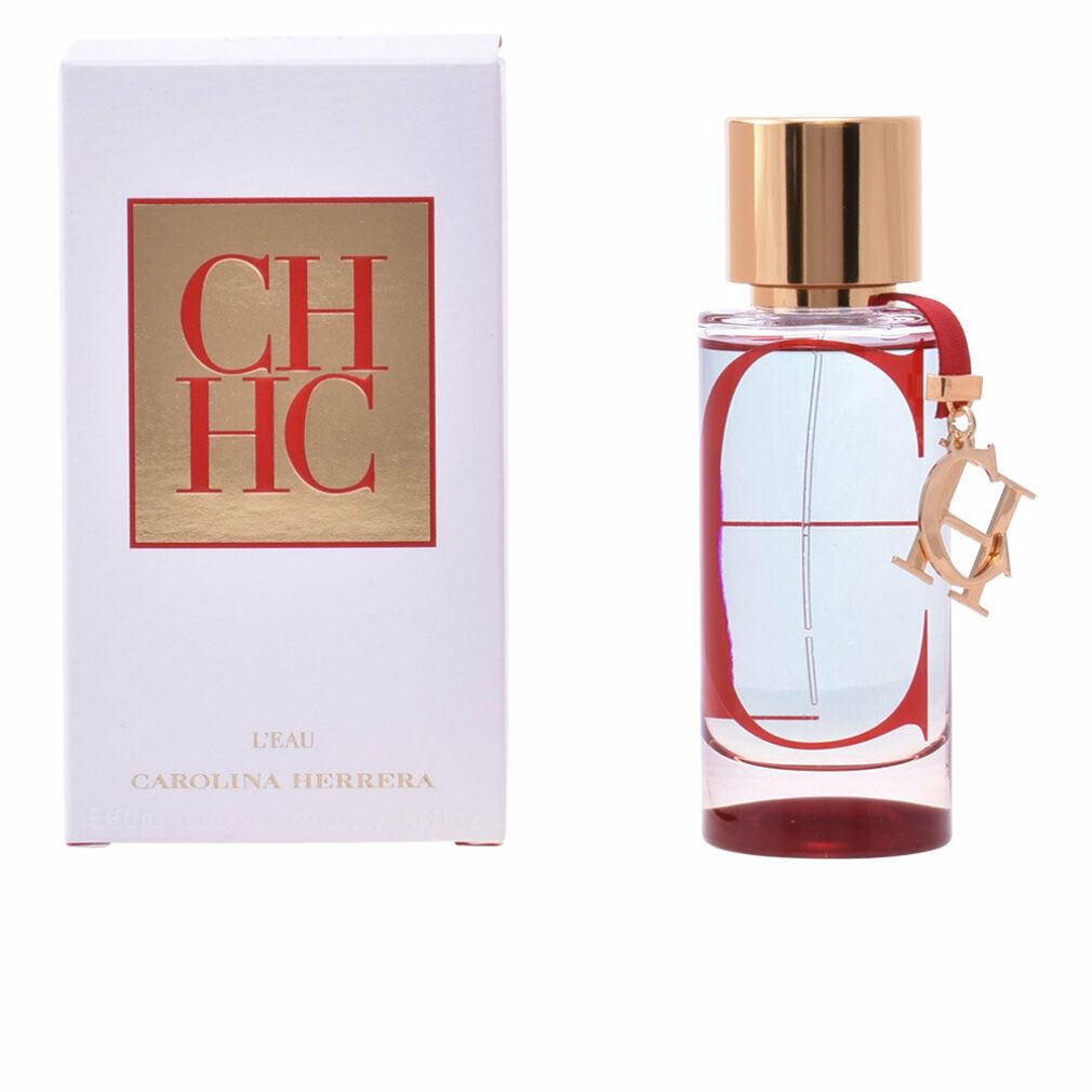 Parfümflasche mit roter Verzierung und goldener Kappe, neben einer weißen Schachtel mit Logo.