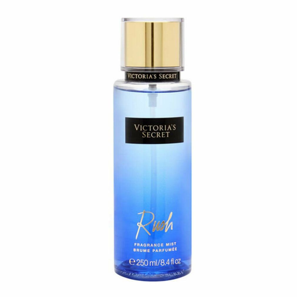 Victoria's Secret Rush Fragrance Mist. Blaue Flüssigkeit in einer zylindrischen Flasche. Goldfarbener Deckel. Produktname auf Etikett.