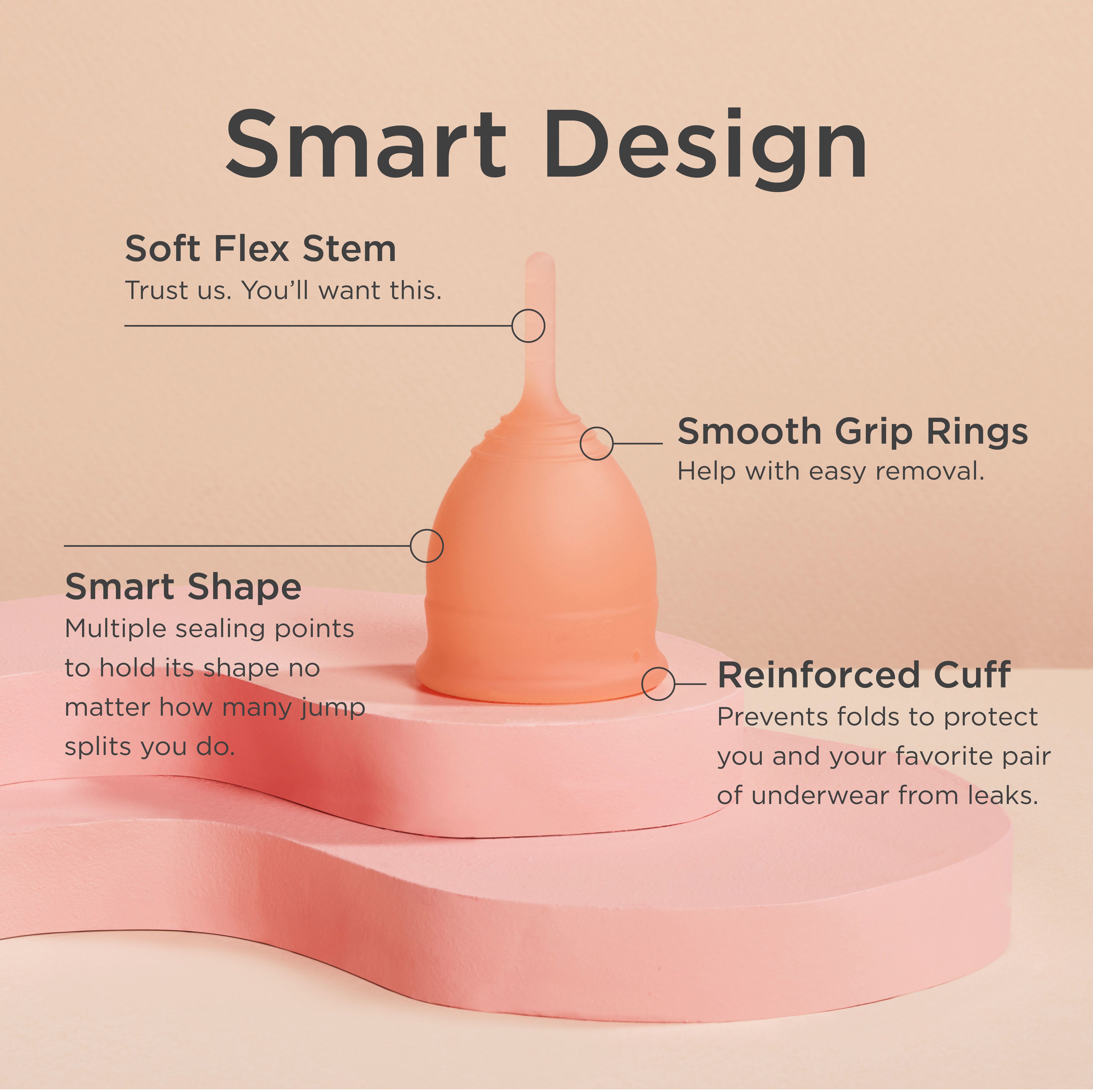 Weiche Menstruationstasse, peachfarben, mit Griff, Ringe und verstärktem Rand. Beschriftung: Smart Design.