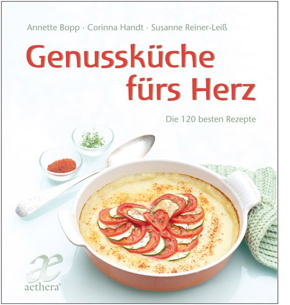Kochbuch mit Titel "Genussküche fürs Herz". Auf dem Cover ein Gericht mit Tomaten und Zucchini in Herzform. Aethera-Logo.