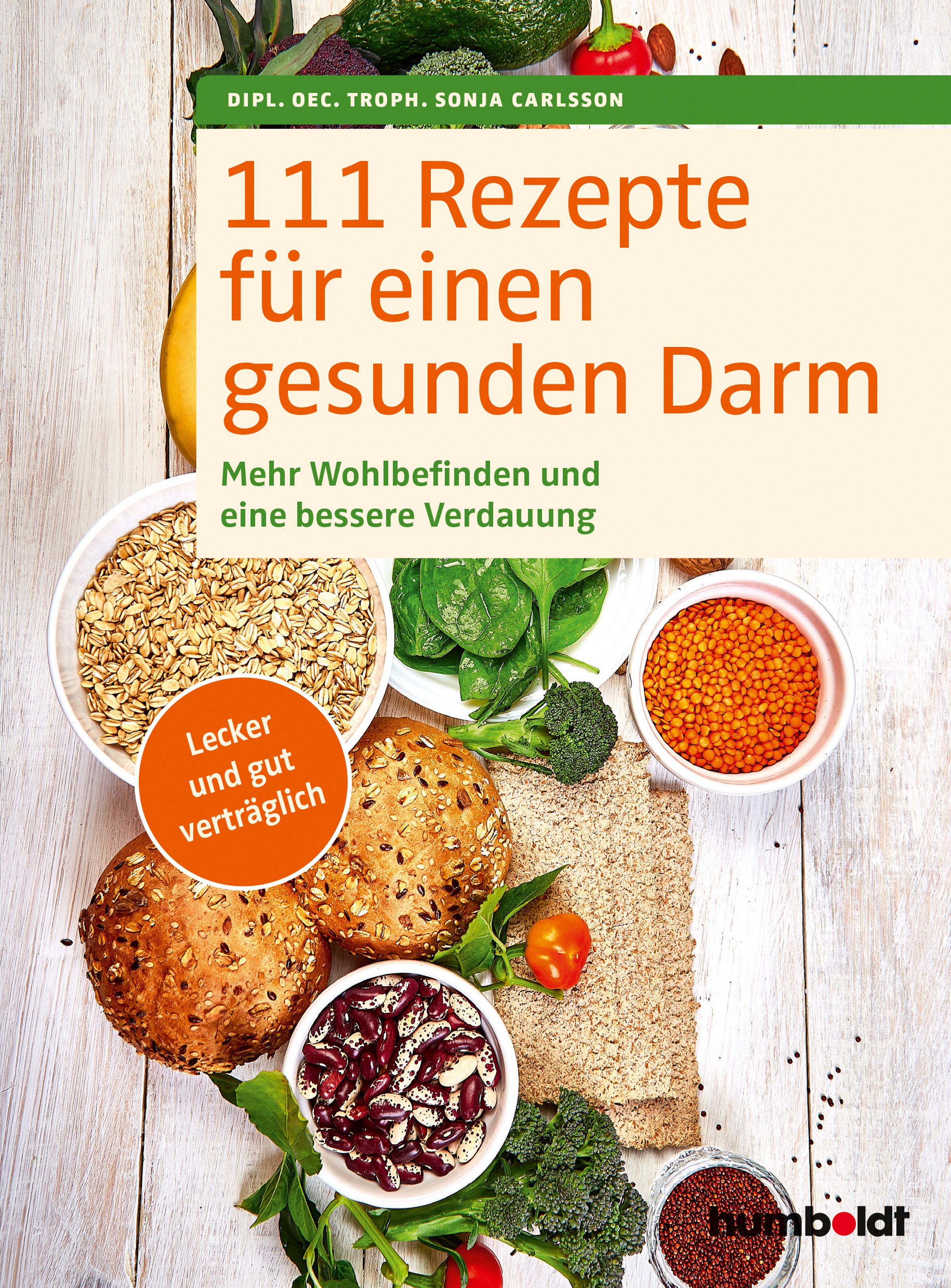 Buchcover: 111 Rezepte für einen gesunden Darm. Titel und Autorin. Auf dem Tisch: Zutaten wie Gemüse, Hülsenfrüchte und Brot.