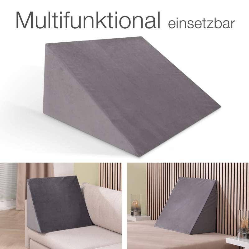 Graues Keilkissen, multifunktional einsetzbar. Präsentation auf Sofa und Bett. Eckige Form, aus weichem Stoff.
