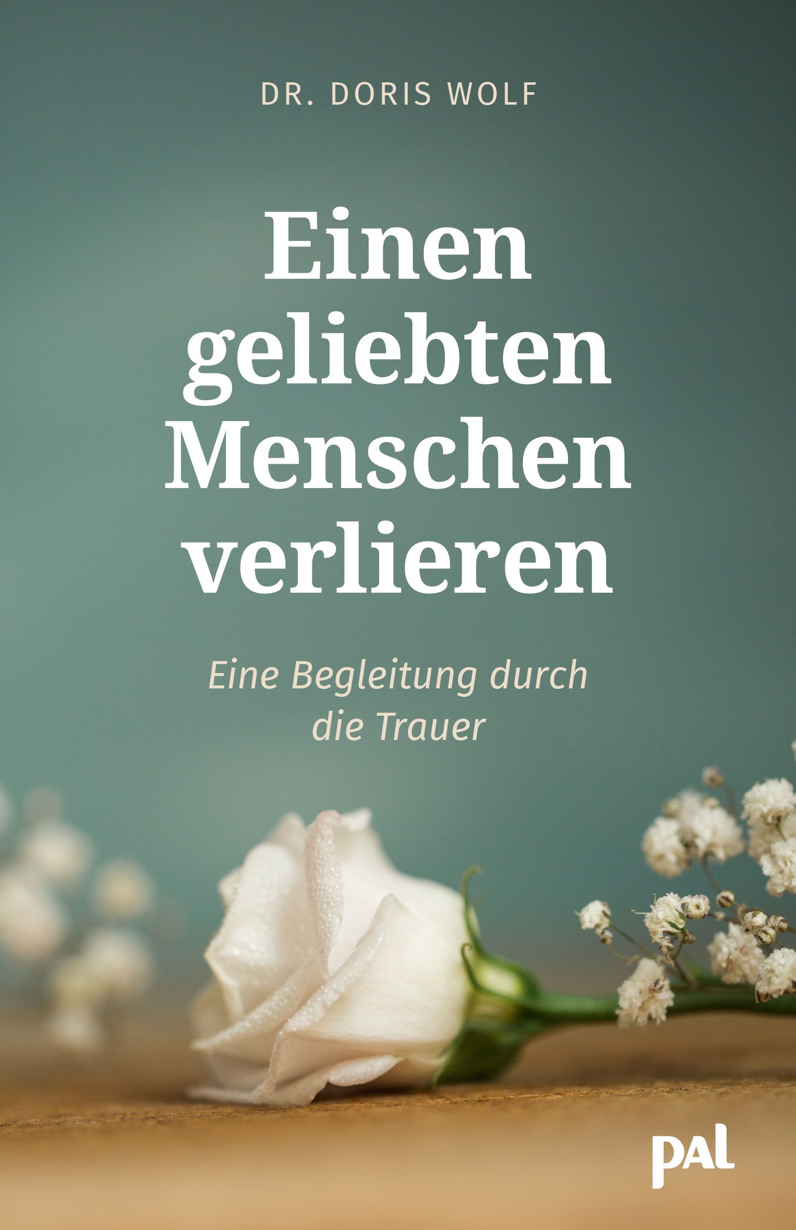 Buchcover mit Titel: Einen geliebten Menschen verlieren. Autor: Dr. Doris Wolf. Weiße Rose und Blütenzweige vor unscharfem Hintergrund.