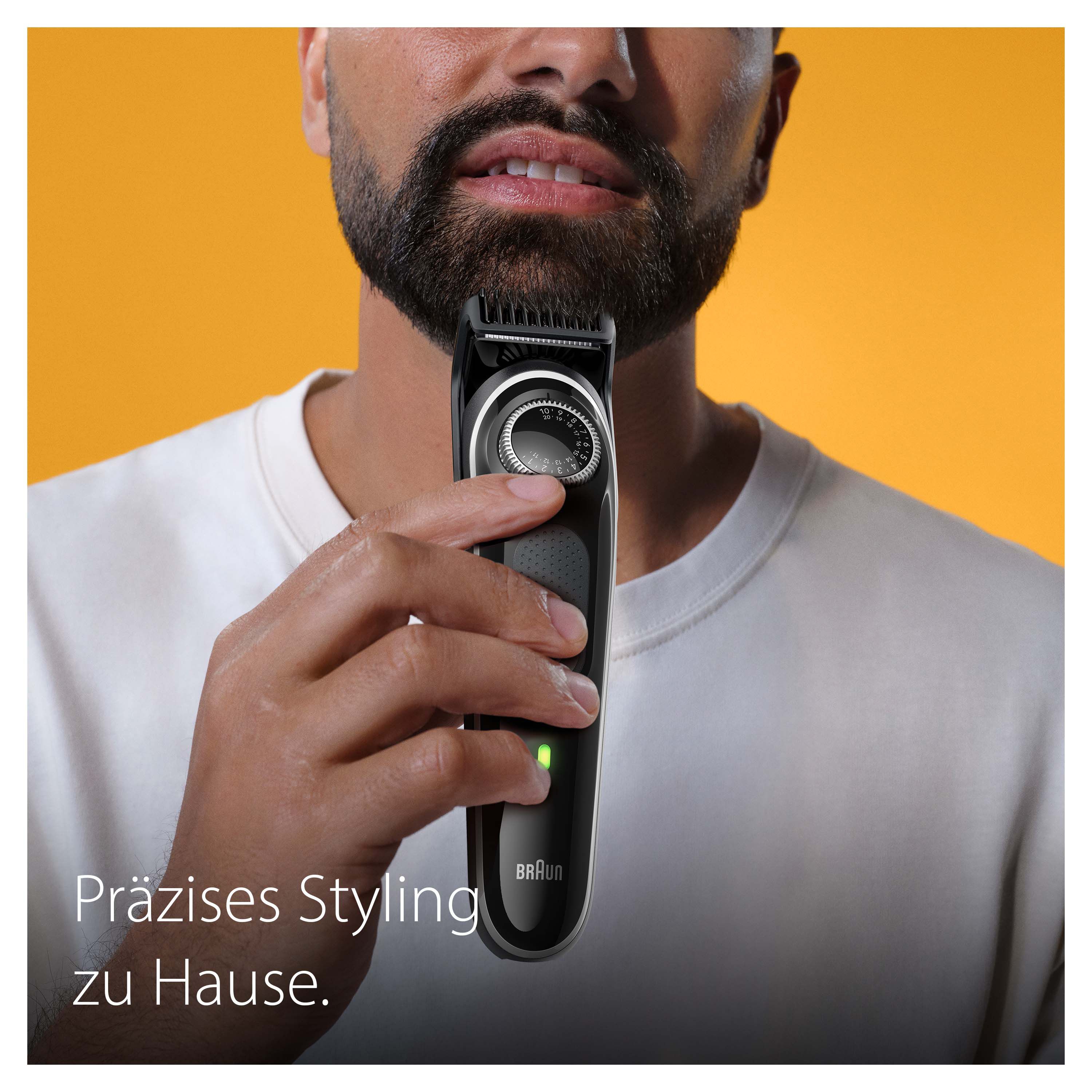 Mann stylt Bart mit Braun Bartschneider BT3440. Präzises Styling zu Hause.