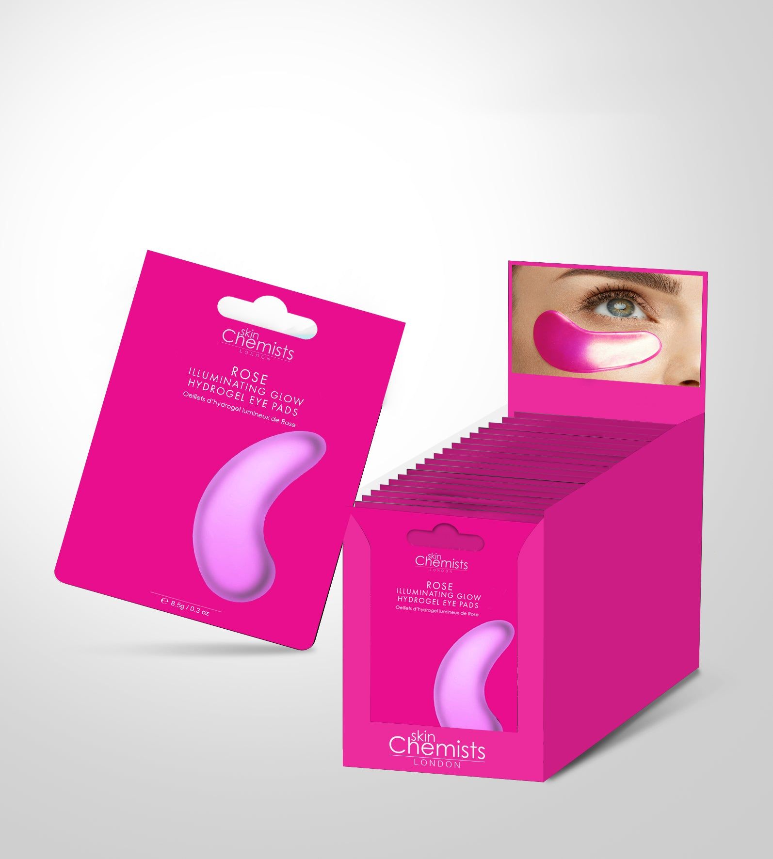Rosa Produktverpackung mit Augenpads, daneben eine Displaybox mit weiteren Packungen. Produktname sichtbar.