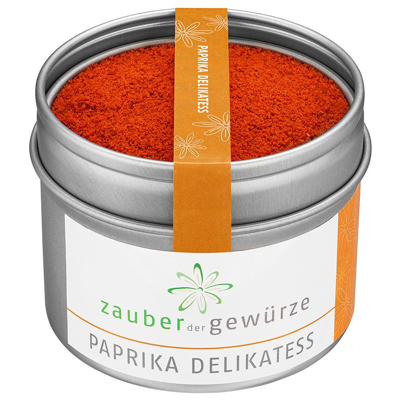 Runde Dose mit Paprika delikatess. Orangefarbenes Pulver in Dose. Etikett mit Produktnamen und Logo. Orangefarbener Streifen mit Text.