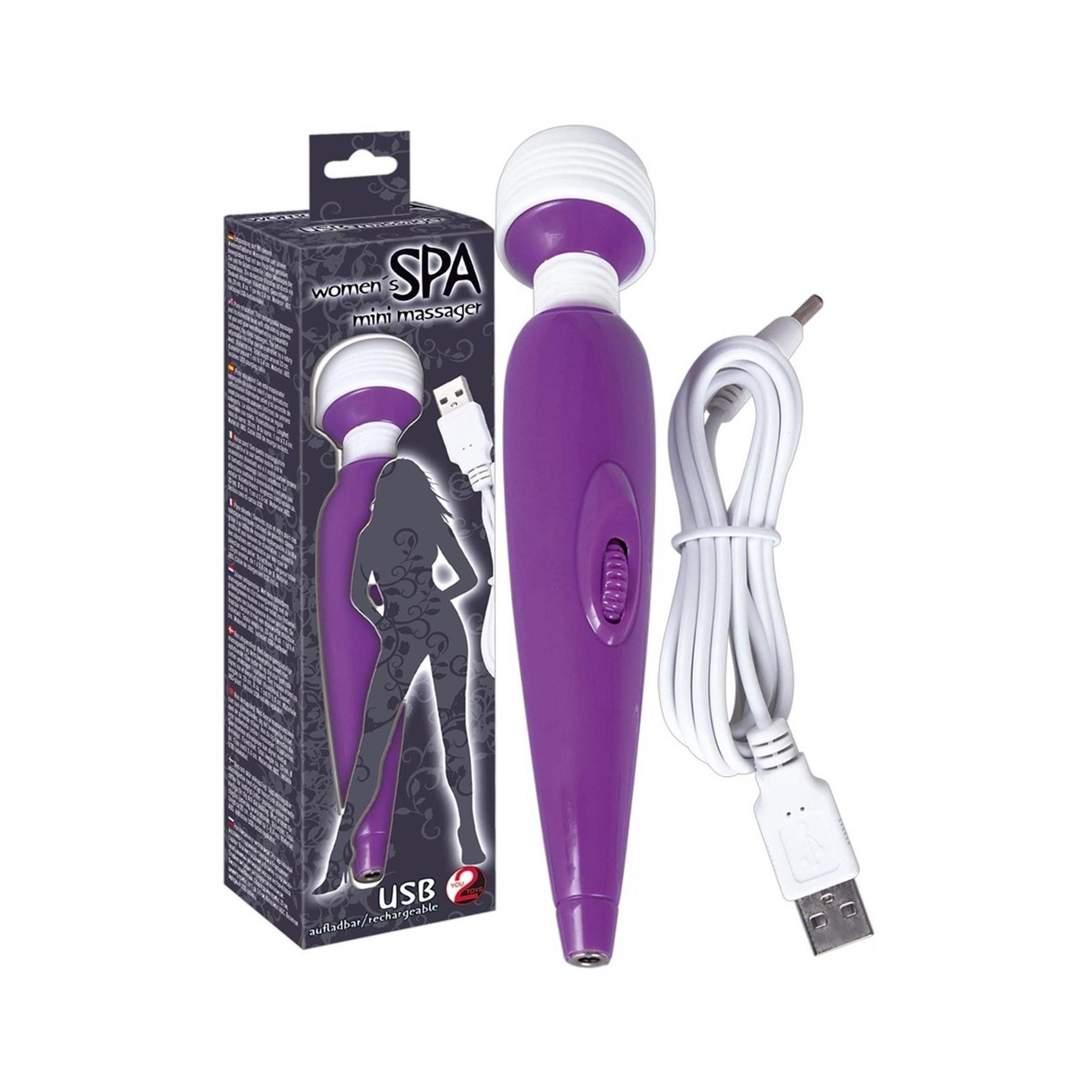 Mini-Massagegerät mit Verpackung. Lila Gerät, weißes Kabel. Schwarze Schachtel mit Produktbild.