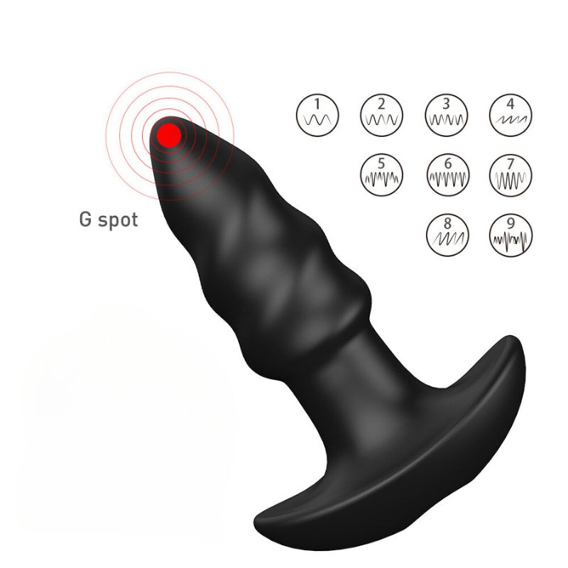 Schwarzer, geriffelter Analplug mit T-förmiger Basis. G-Punkt-Kennzeichnung. Vibrationsmodi.