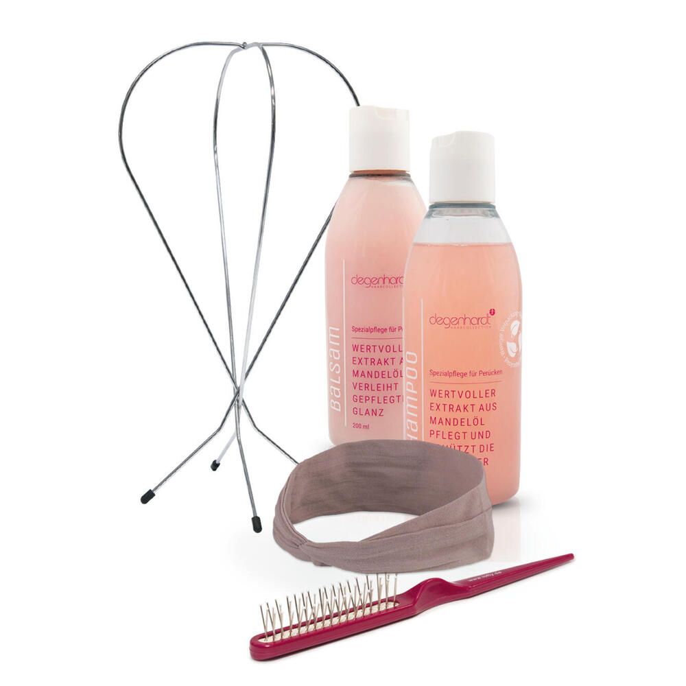 Set mit Haarpflegeprodukten. Enthält zwei Flaschen, einen Haarreifen, eine Bürste und einen Metallrahmen.