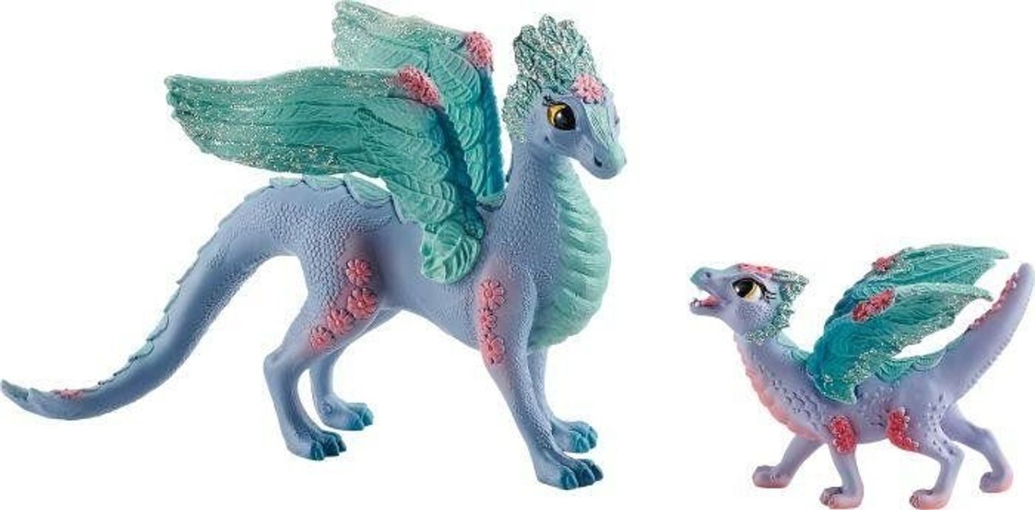 Zwei lilafarbene Drachenfiguren mit blauen Flügeln und roten Akzenten. Ein großer und ein kleiner Drache.