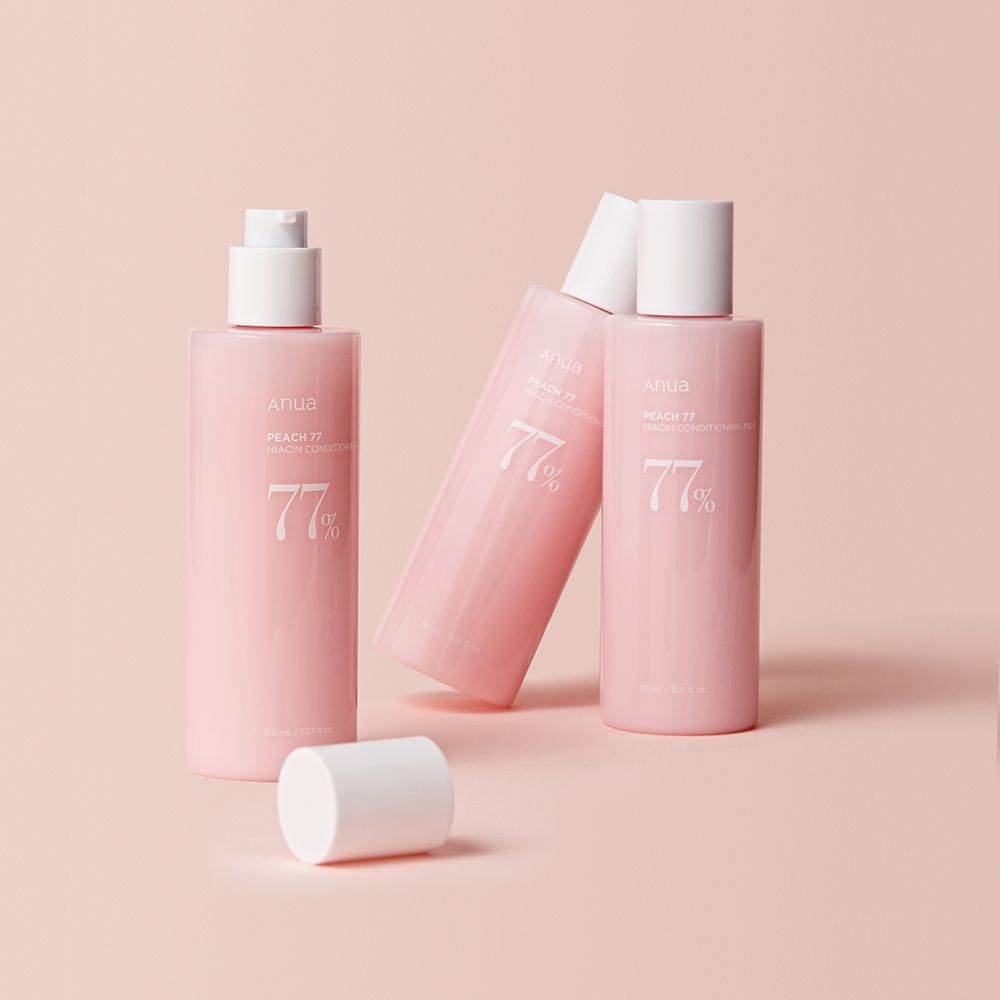 Drei Anua Peach 77% Tonerflaschen, eine liegend, mit weißen Deckeln.