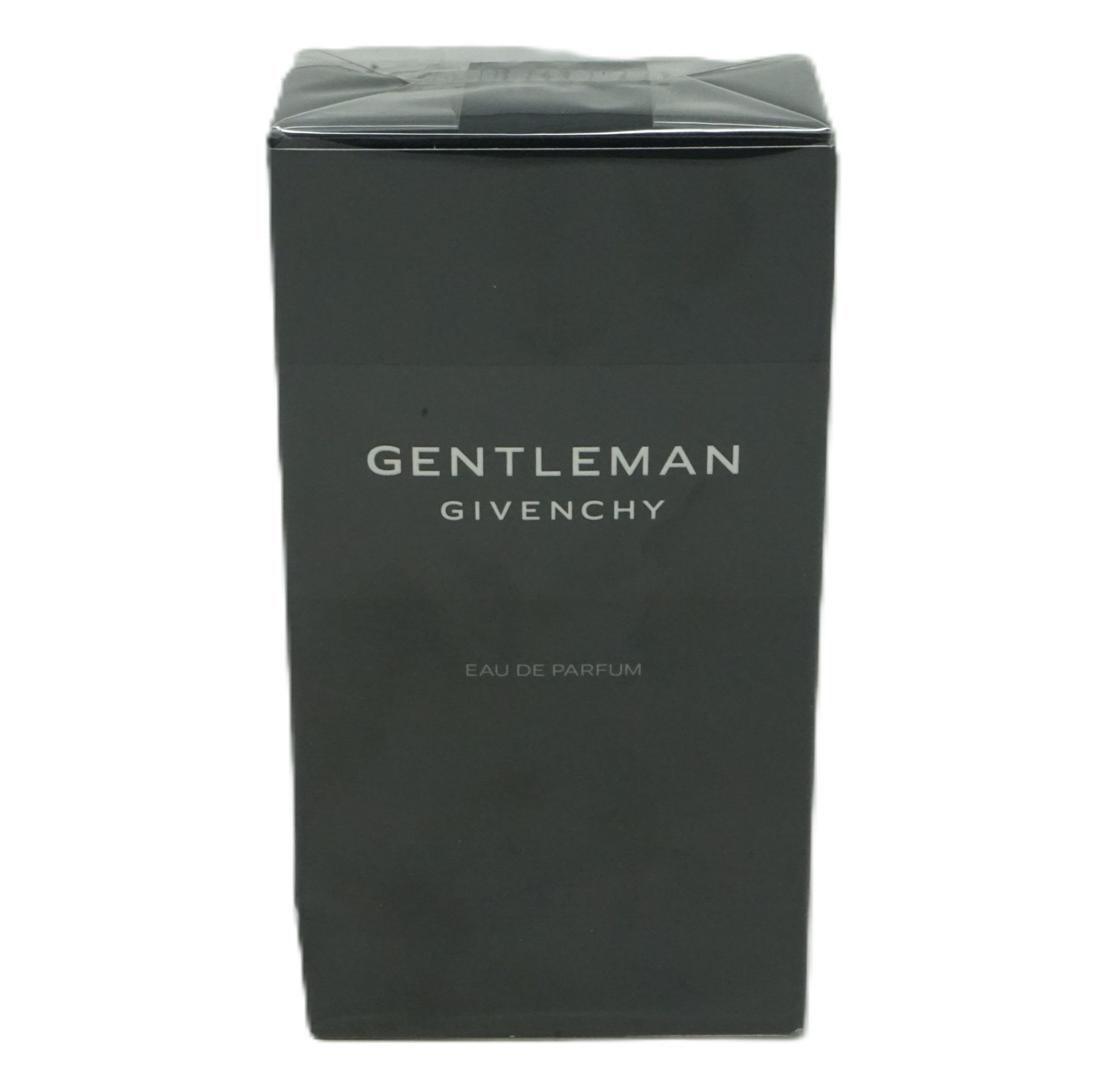 Schwarzer Karton mit weißem "GENTLEMAN GIVENCHY" Schriftzug. "EAU DE PARFUM" darunter. Verschlussfolie.