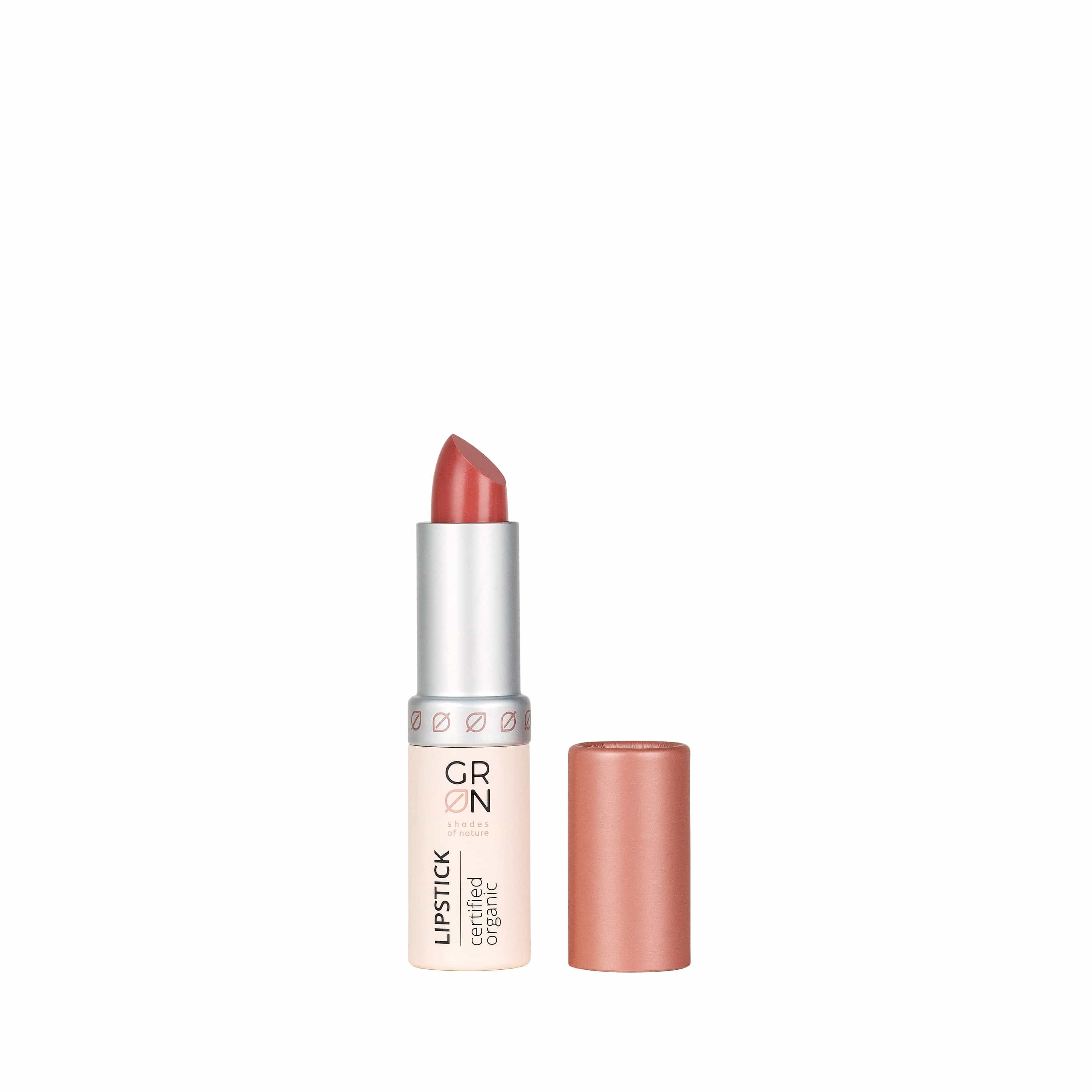 Lippenstift, geöffnet, mit rosafarbenem Stift. Silberfarbener Schaft, rosafarbene Kappe. Aufschrift: GRN, Lipstick, certified organic.
