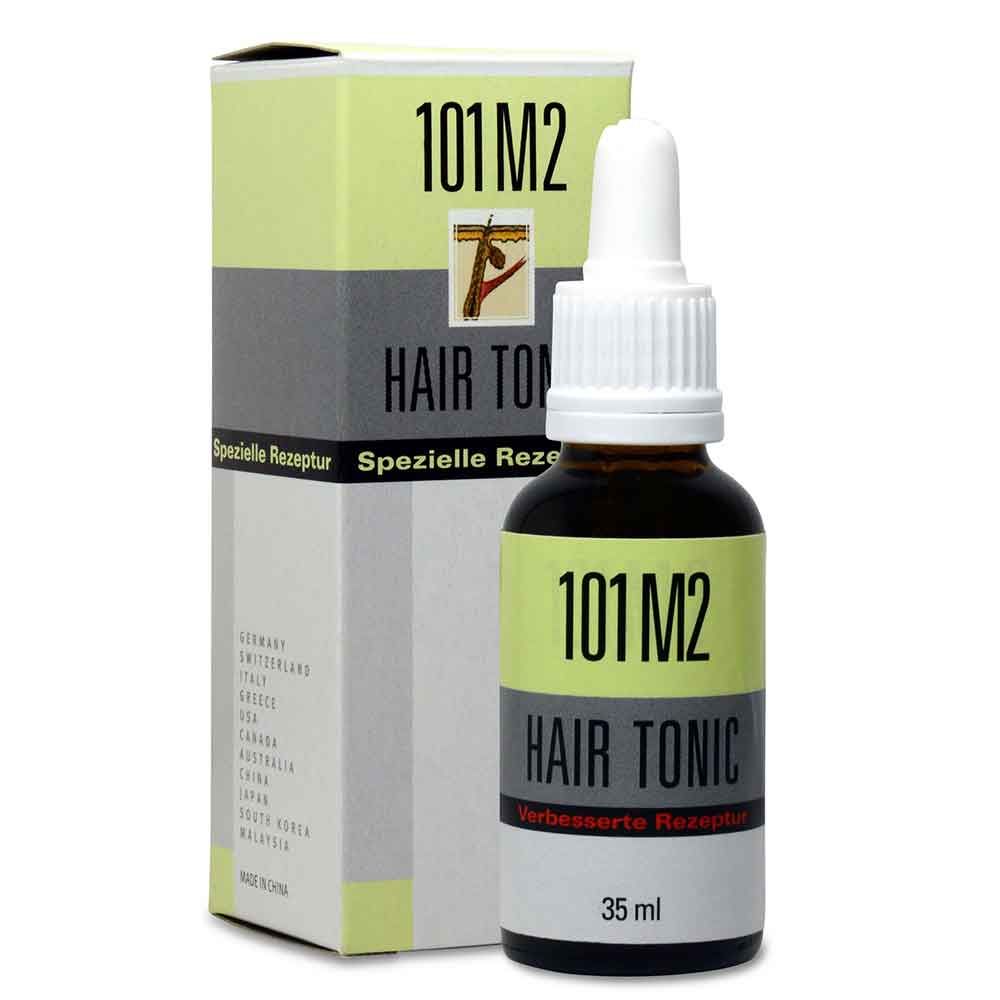 Braune Glasflasche mit weißem Tropfer und Karton. Aufschrift: 101 M2 Hair Tonic. Auf dem Karton: Spezielle Rezeptur.