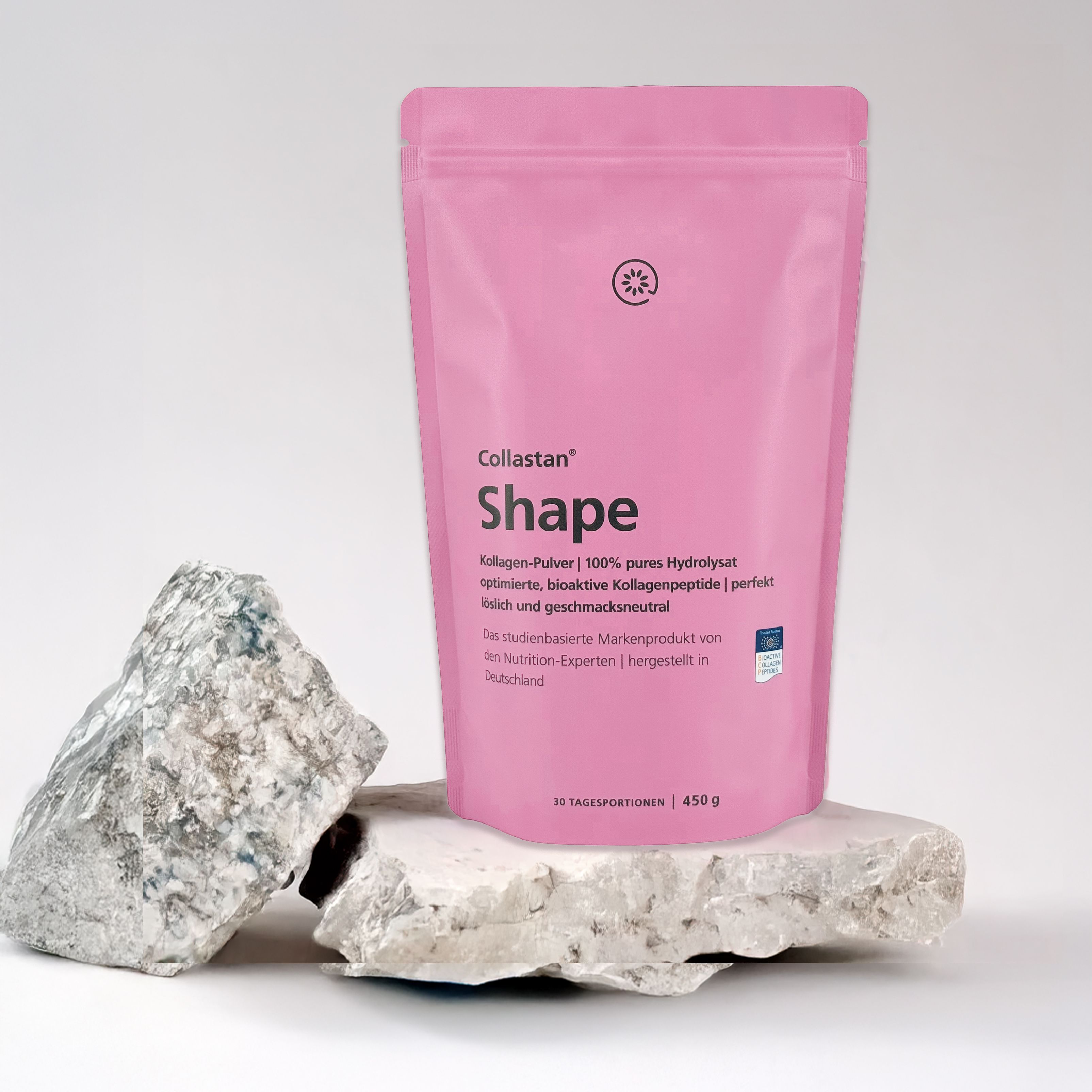 Pinke Verpackung von Collastan Shape auf Stein. Text: Kollagen-Pulver. 450g. Marke: Collastan Shape. Logo.