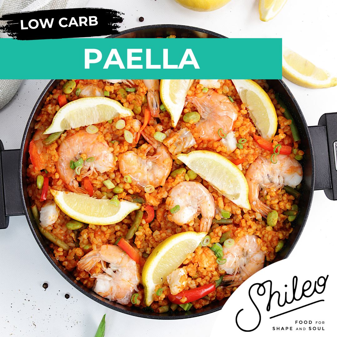 Pfanne mit Paella. Garnelen, Zitronenscheiben, Gemüse. Text: SHILEO, Food for Shape and Soul, Low Carb.