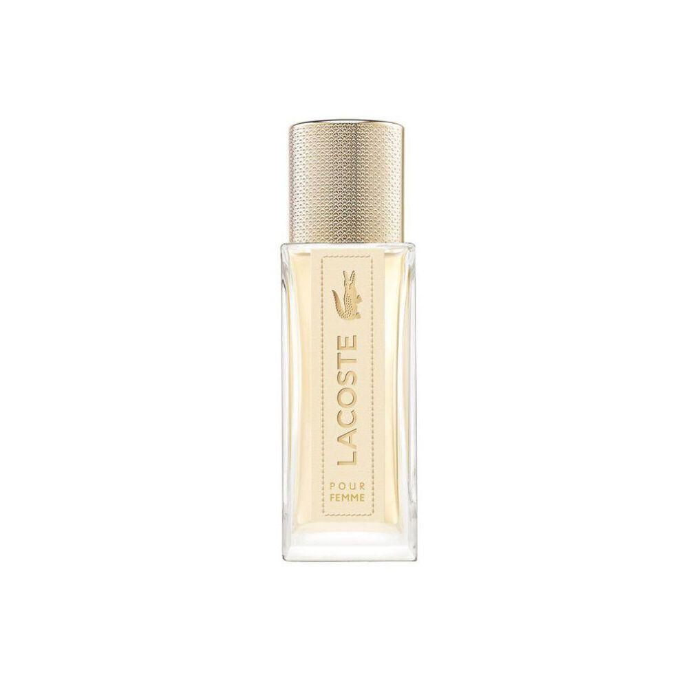 Lacoste Pour Femme EdP Nat. Spray. Rechteckiger Flakon mit goldfarbenem Verschluss. Aufschrift Lacoste und Krokodil-Logo.
